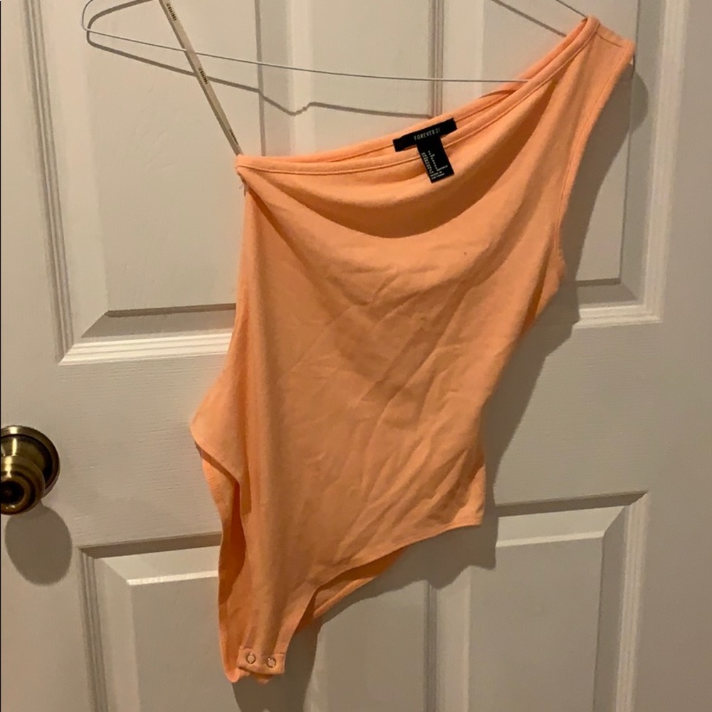Peach colored one shoulder bodysuit
